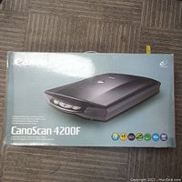 Closed original packaging box showing Canon CanoScan 4200F branding and image of scanner.
