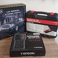Overview of three sealed boxes: LED marker strobe lights, TPMS diagnostic tool case, and ArtiLink600 scanner box.