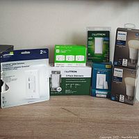 Wide view of the entire lot showing all packs and boxes including dimmers, smart plugs and light bulbs.