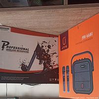 Photo showing boxed professional wireless microphone set and boxed JYX JYX-66BT portable speaker.