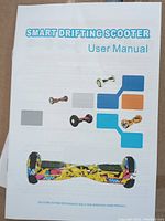User manual of the Smart Drifting Scooter showing colorful model designs for reference.