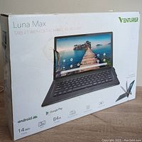 Front view of the tablet box showing image of tablet with detachable keyboard, specs including Android OS, 14 inch display, 64GB RAM, and Google Play compatibility.