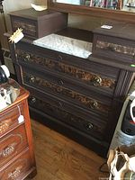 Front angle showing full chest including marble top and smaller side drawers.