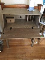 Open desk showing inside cubbies and fold-down lid