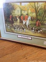 Framed large hunt print with riders, hounds, and horses in a manor setting.