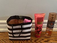 Full lot showing both items and Sephora gift bag on wooden floor against white wall.