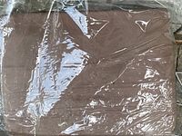 Queen taupe bed sheet set folded and sealed in clear plastic packaging.