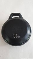 Front view of the black JBL Clip Bluetooth speaker showing the JBL logo and built-in clip.