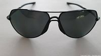 Front view of Nike Outrider black metal frame sunglasses with dark polarized lenses.