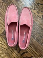 Top view of the pink Rockport loafers showing the shoe shape, stitching, and brand name inside the shoe.