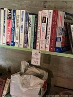 Books on a shelf showing titles mainly about finance and self-help