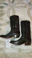 Pair of men's dark brown cowboy boots laid side by side showing full side profile