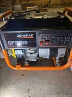 Front right angle view showing control panel, two 120V duplex outlets, twist-lock outlet, engine housing and tubular frame