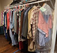 Men's and women's clothing assortment hanging on rack