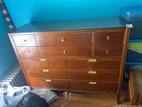 Front view of entire dresser showing all 12 drawers and glass top.