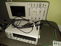 Front view showing oscilloscope and function generator with probes and cables
