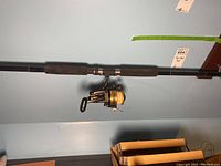 Photo showing full assembly of Penn 650SS spinning reel mounted on St. Croix fishing rod with foam grips.
