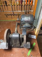 Side view of Craftsman bench grinder with capacitor motor model 115-6963 showing grinding wheels, metal base, and power cord.