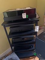 Front view of shelving unit holding audio components