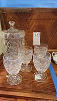 Photo of the Imperial cut glass lead crystal lidded canister alongside four Waterford low goblets showing overall lot contents.