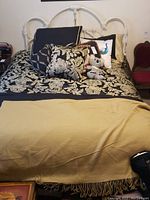 Front full view of the bedframe and bedding with decorative cushions