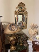Photo showing lamp base and decorative lampshade alongside faux flower arrangement and classical bust sculpture for context.