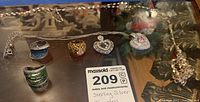 Full lot display of rings, pendants and necklace chain on glass surface