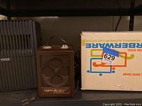 Original disc electric heater in brown and Vento air filter next to boxed Farberware canning stock pot