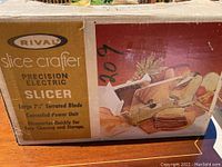 Original box of Rival Slice Crafter electric meat slicer showing branding, features and image of the unit