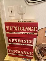 Stack of three Vendange boxed stemware sets with one glass displayed on top, showing packaging and product.