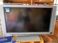 Front view of the Sony Bravia flatscreen TV showing the screen and frame with a label sticker 665 on the top left corner.
