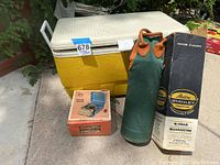 Photo showing the vintage Igloo cooler, Coleman camp stove box, and Stanley thermos in green carrying case with original thermos box.