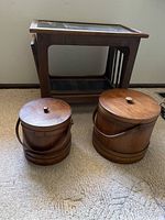 Wooden side table with two wooden round sewing notions baskets in front