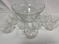 Full set including the punchbowl and 11 matching glasses arranged around it, showing overall condition and design.
