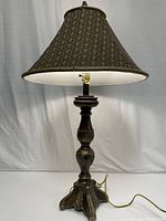 Image showing the full 37-inch table lamp with metal base and dark patterned cloth shade hanging from the top.