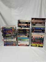 Full view of 43 VHS tapes stacked showing variety of movie titles including Disney classics and other genres.