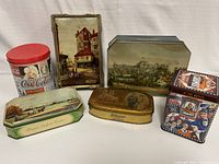 Photo showing the full assortment of six vintage collectible tins grouped together for overview.