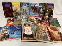 Group photo of the 18 youth non-fiction books arranged on a white surface, showing cover titles and illustrations.
