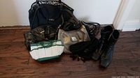 Full view of all bags, boots, and scarf arranged on floor showing colors and materials.