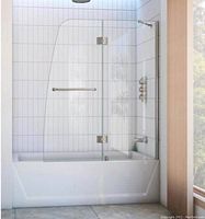 Installed tub door with clear glass and brushed nickel hardware mounted on bathtub.