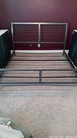 King size pewter metal bed frame with headboard and footboard, showing rails and 7 wooden slats for mattress support.