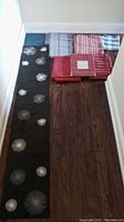 Full view of all table accessories laid on floor showing table runner, placemats, and tablecloths.