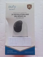 Front of Eufy indoor security camera retail box highlighting 2K resolution and AI technology.