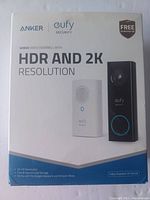 Front of the box showing Anker Eufy wired video doorbell with HDR and 2K resolution and images of doorbell camera and chime unit.