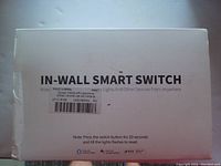 Box for in-wall smart switch showing basic branding, instructions, and compatibility with WiFi and IFTTT.