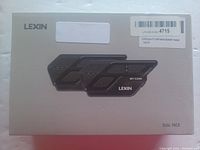Photo of the front of the boxed product showing image of two LEXIN ET-Com Bluetooth headsets and branding.