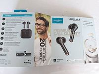 Opened box with Liberty Air 2 Soundcore earbuds packaging, showing features and specs.