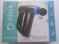 Closed product box front showing Njoie N-Force massage gun image and product features highlighting deep muscle therapy, 5 speed settings, improved circulation, and workout recovery.