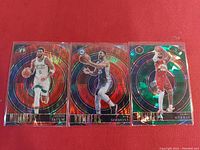 Front side of three Select Numbers NBA cards featuring Jayson Tatum, Ben Simmons, and Jamal Murray, showing their player images and holographic backgrounds.