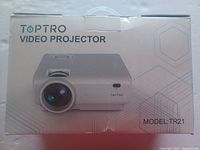Front view of the Toptro video projector box displaying brand, product type, and model number TR21.